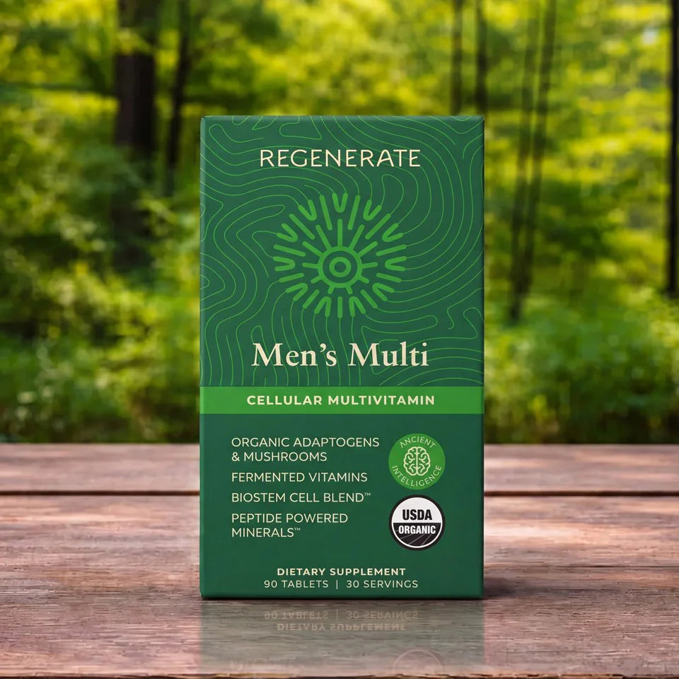 A green box of Regenerate Men's Multi Cellular Multivitamin standing on a wooden surface with a blurred forest background.